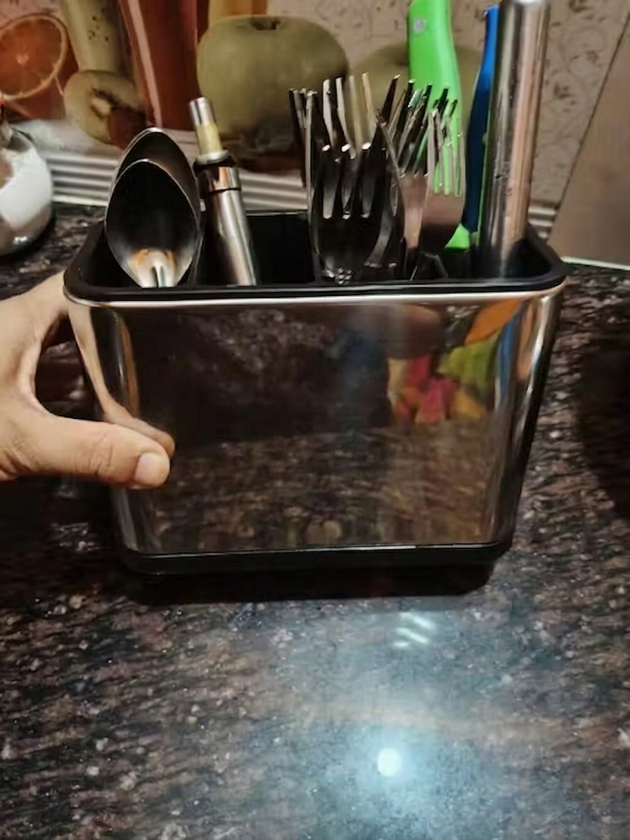 Customer photo - close-up of organizer loaded with steel forks and ladle on granite counter
